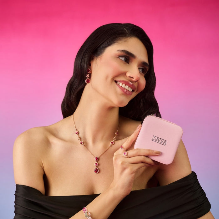 Smiling woman wearing a 925 Sterling Silver dark pink solitaire rose gold necklace holding a box – Zavya