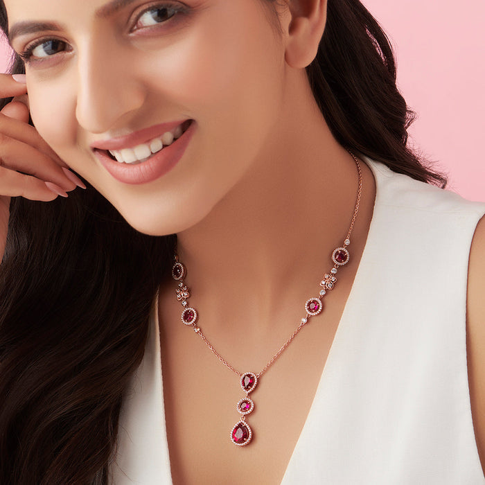 Smiling woman wearing a 925 Sterling Silver rose gold-plated dark pink solitaire necklace. Women's jewelry – Zavya