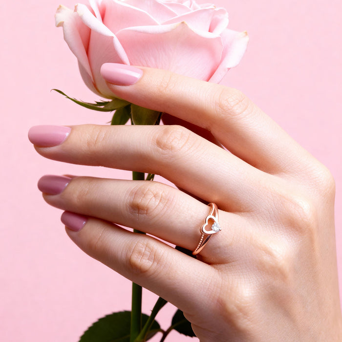 Hand holding a rose wearing an adjustable rose gold 925 Sterling Silver heart ring. Women's jewellery – Zavya