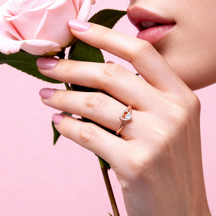 Woman holding a pink rose wearing a rose gold plated 925 Sterling Silver heart ring. Women's jewellery – Zavya