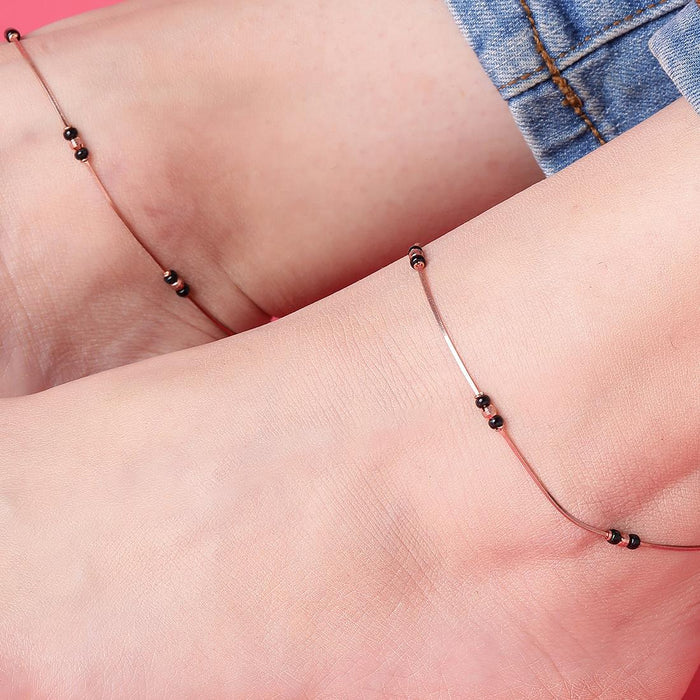 Rose gold-plated 925 Sterling Silver anklet with black beads on a woman's ankle. Women's jewellery – Zavya