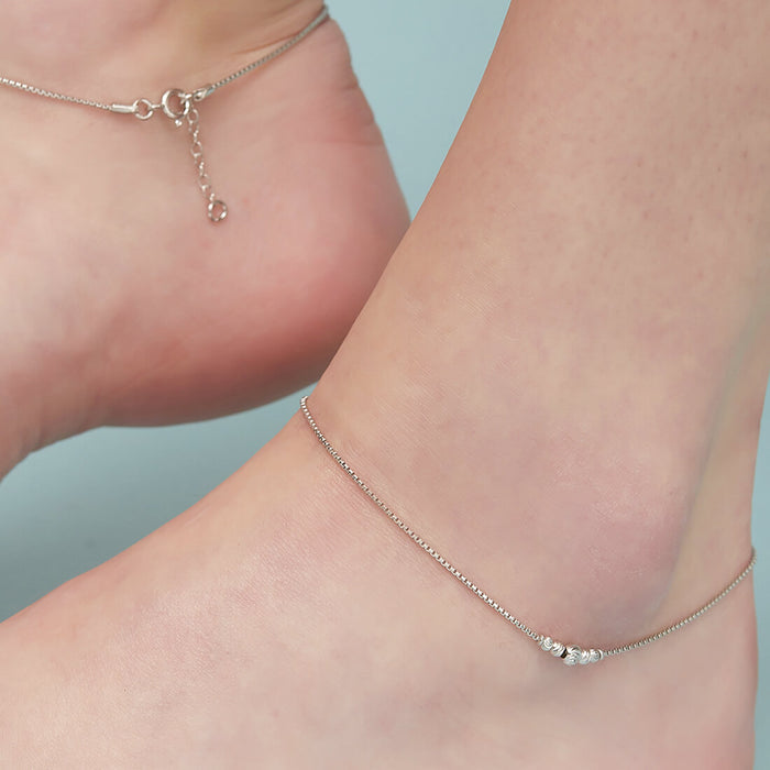Woman wearing a bold bead 925 Sterling Silver anklet. Everyday silver jewellery for women – Zavya