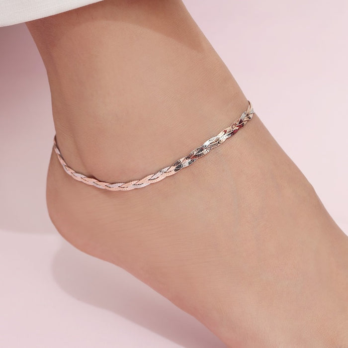 Woman wearing a braided dual tone 925 Sterling Silver anklet. Elegant silver jewellery for women – Zavya