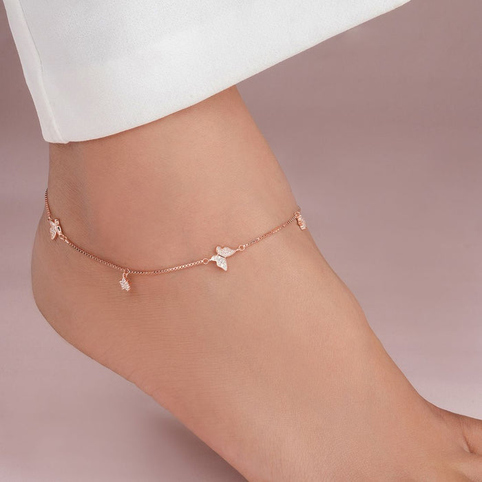 Rose gold 925 Sterling Silver anklet with CZ butterfly charms worn on a woman's ankle. Fine jewellery – Zavya