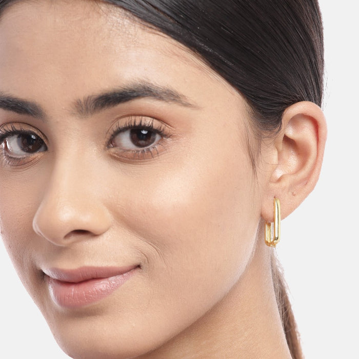 Woman wearing a classic gold plated geometrical hoop earring in 925 Sterling Silver. Earrings for women – Zavya