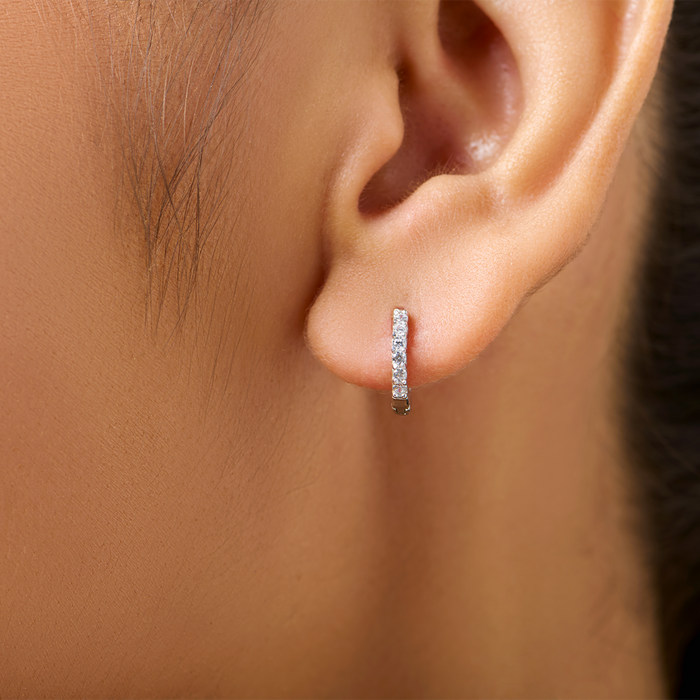 Woman wearing small studded 925 Sterling Silver hoop earrings. Everyday jewellery for women – Zavya