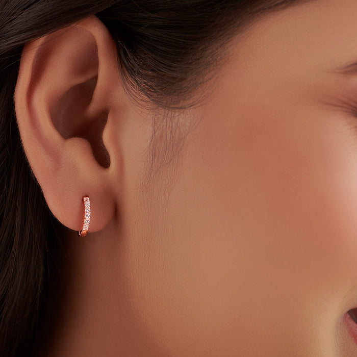 Woman wearing a classic studded rose gold hoop earring. 925 Sterling Silver women's jewellery – Zavya
