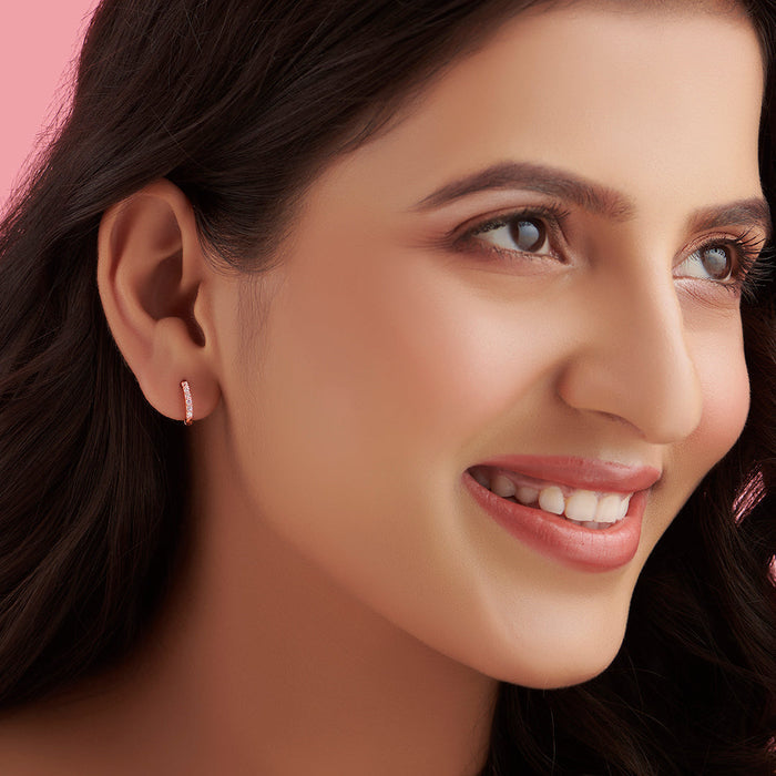 Smiling woman wearing 925 Sterling Silver rose gold hoop earrings. Everyday jewellery for women – Zavya