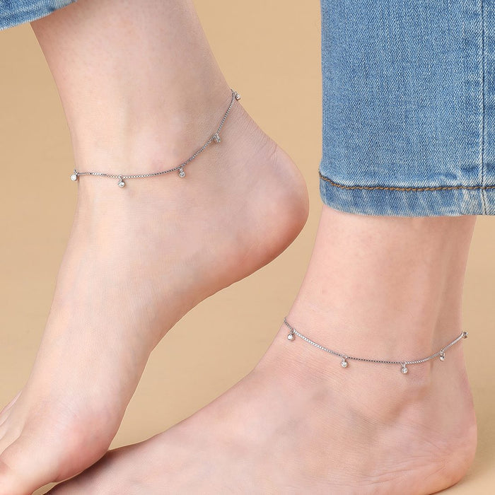Woman wearing delicate 925 Sterling Silver anklets with CZ drops. Silver jewelry for women – Zavya