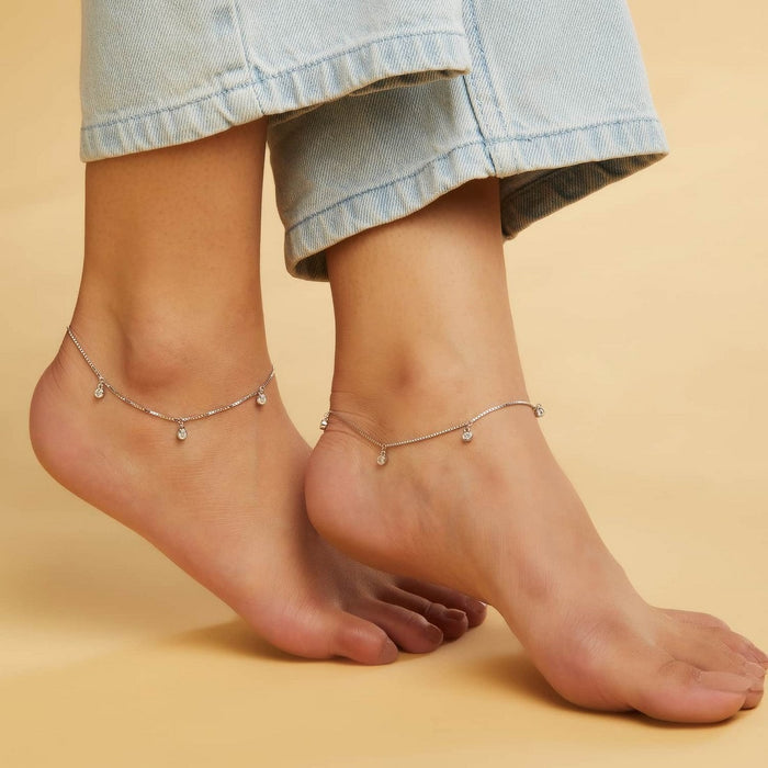 Woman's bare feet wearing a Drop CZ 925 Sterling Silver anklet. Elegant women's silver jewellery – Zavya