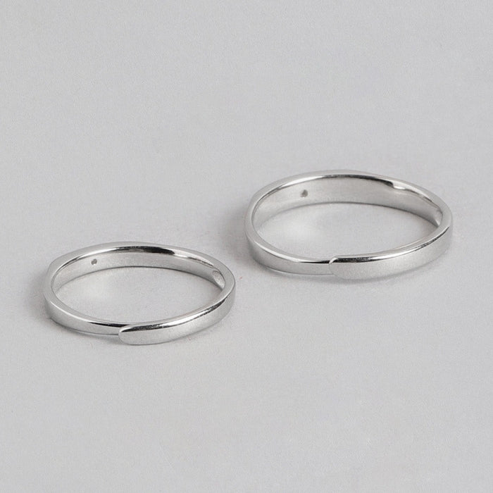 Two sleek, adjustable 925 Sterling Silver couple rings for women, showing smooth overlapping bands. – Zavya