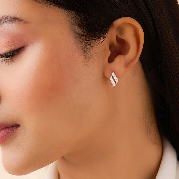 Woman wearing 925 Sterling Silver dancing wave earrings. Rhodium plated jewellery for women. – Zavya