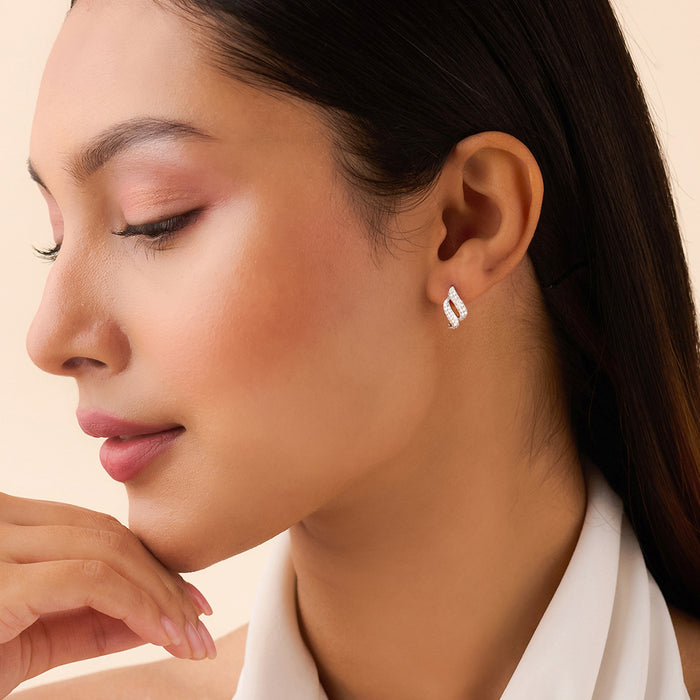 Woman wearing 925 Sterling Silver wave stud earrings. Beautiful everyday silver jewellery for women. – Zavya