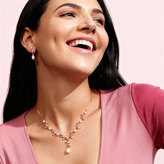Smiling woman in a rose gold 925 Sterling Silver pendant necklace with CZ & pearls. Women's jewellery – Zavya