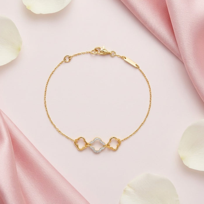 Gold plated 925 Sterling Silver clover bracelet on pink silk with white flower petals – Zavya
