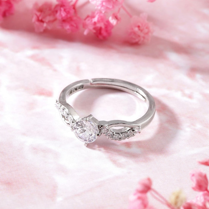 Adjustable 925 Sterling Silver ring for women with sparkling round CZ stones on a pink background – Zavya