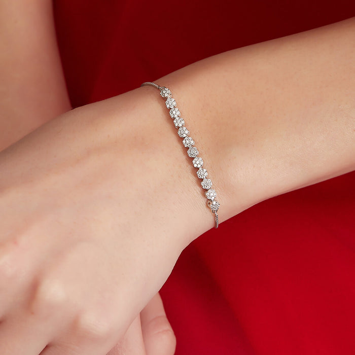 Woman wearing a sparkling floral 925 Sterling Silver bracelet on her wrist. Elegant jewelry for women – Zavya