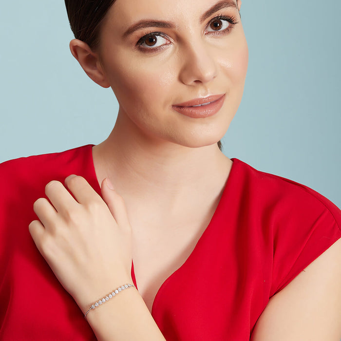 Woman in red wearing a 925 Sterling Silver floral bracelet. Elegant silver jewellery for women – Zavya