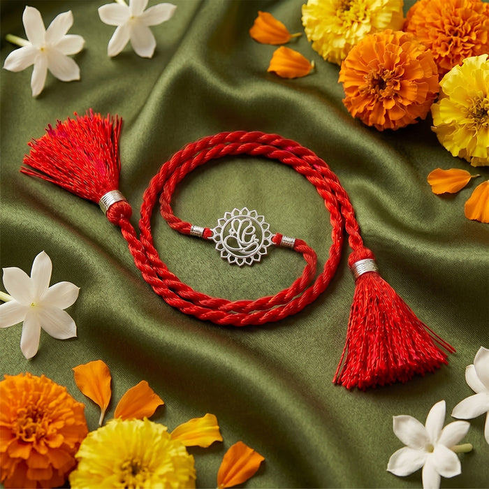 Divine Floral Ganesha Silver Rakhi Dry Fruits Gift Hamper