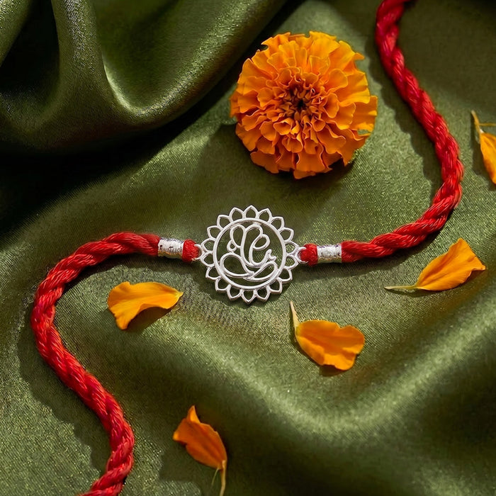 Divine Floral Ganesha Silver Rakhi Dry Fruits Gift Hamper