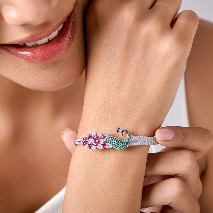 Woman wearing a 925 Sterling Silver peacock bracelet with pink and green stones. Jewellery for women. – Zavya
