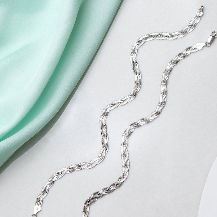 Entangled 925 Sterling Silver anklet for women. Braided chain jewellery beside mint fabric – Zavya