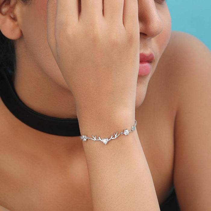 Woman wearing a delicate 925 Sterling Silver bracelet with a crystal heart. Elegant women's jewellery. – Zavya