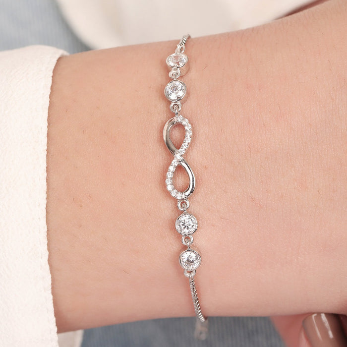 Women's 925 Sterling Silver infinity bracelet with sparkling stones worn on a wrist. Fine jewellery – Zavya
