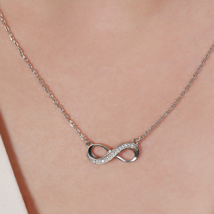 Woman wearing a sparkling infinity 925 Sterling Silver necklace. Elegant silver jewellery for women – Zavya