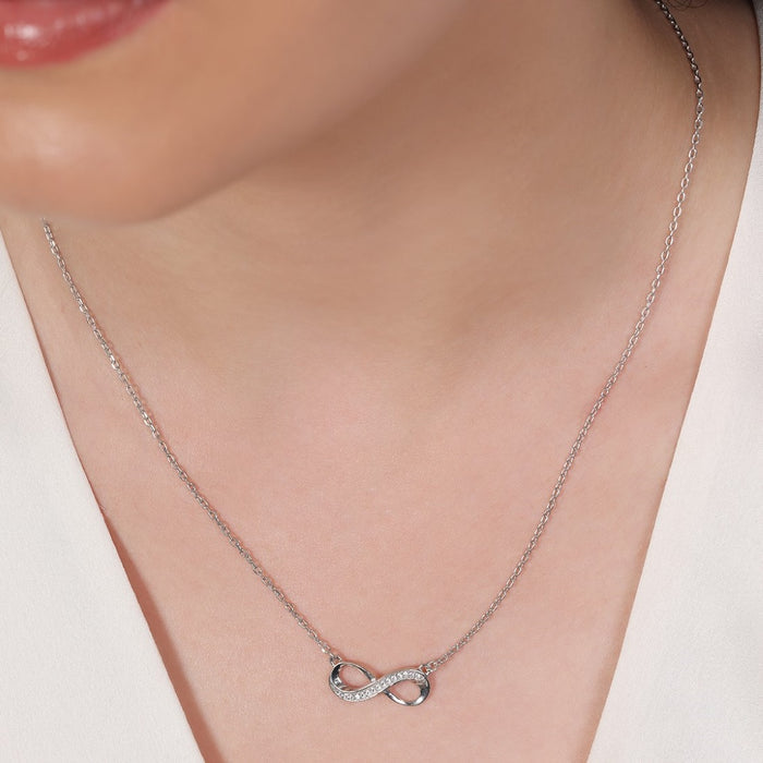 Woman wearing a crystal infinity 925 Sterling Silver necklace. Elegant silver jewellery for women – Zavya