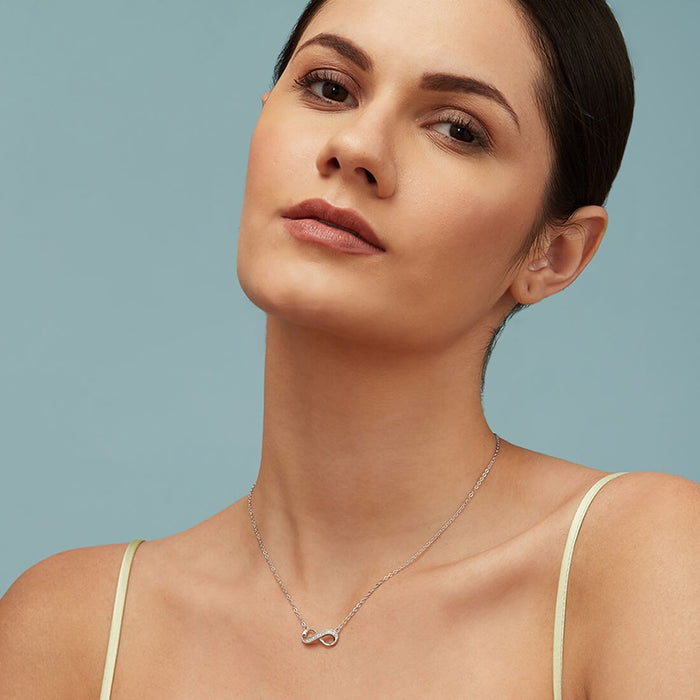 Woman wearing a 925 Sterling Silver infinity pendant necklace. Elegant women's jewellery. – Zavya