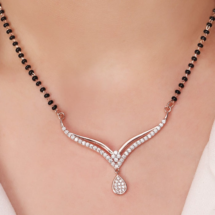 Woman wearing a 925 Sterling Silver mangalsutra necklace with black beads and sparkling drop pendant – Zavya