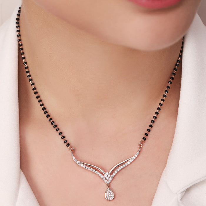 Woman wearing a 925 Sterling Silver mangalsutra necklace featuring black beads and a crystal pendant. – Zavya