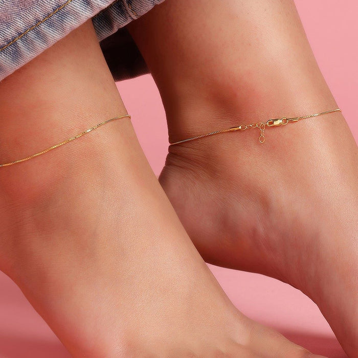 Woman wearing a delicate 925 Sterling Silver box chain anklet. Everyday minimalist ankle bracelet for women. – Zavya