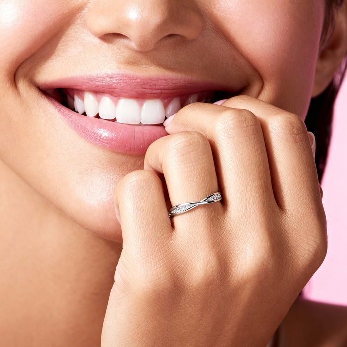 Smiling woman wearing a twisted 925 Sterling Silver ring. Elegant everyday jewellery for women – Zavya