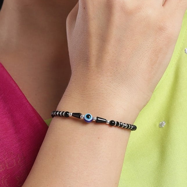 Woman wearing a 925 Sterling Silver evil eye bracelet with black beads. Stylish women's jewelry – Zavya