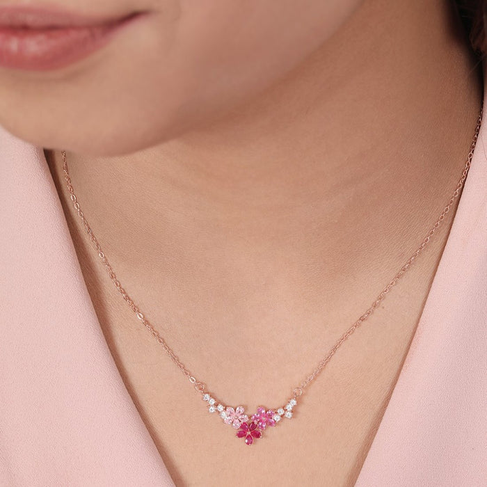 Woman wearing a 925 Sterling Silver rose gold-plated flower necklace with pink stones. Women's jewellery – Zavya