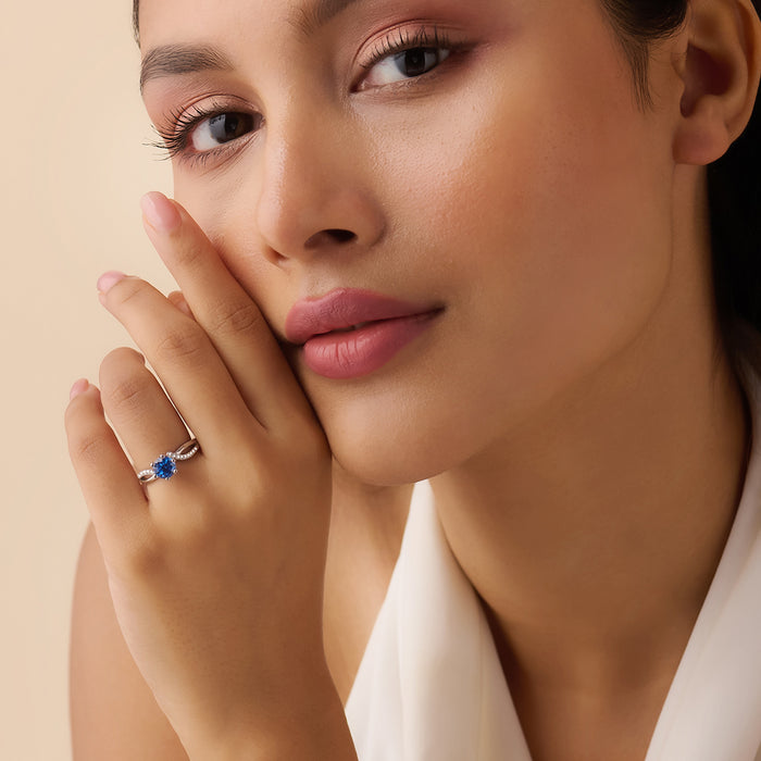 Woman wearing a 925 Sterling Silver blue solitaire ring. Elegant silver rings for women – Zavya