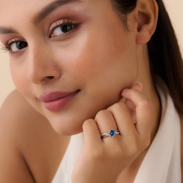 Woman wearing a 925 Sterling Silver blue solitaire ring. Elegant jewellery for women – Zavya