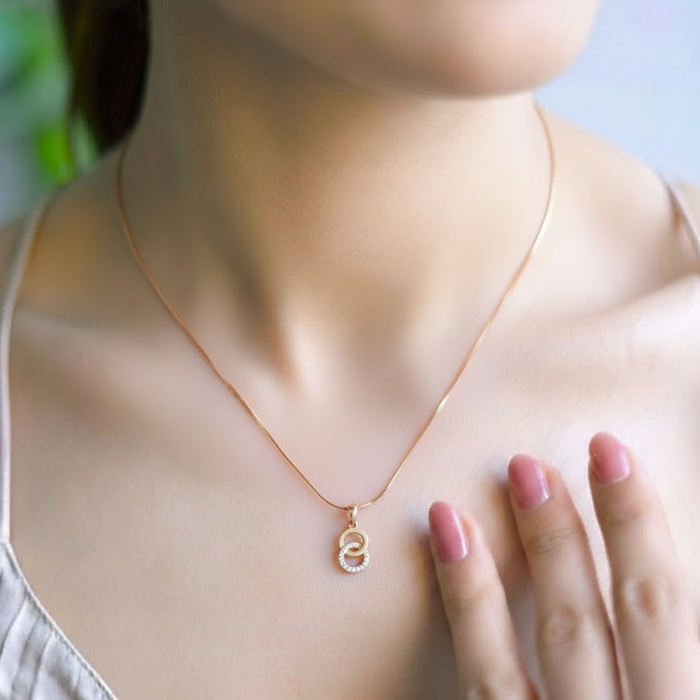 Woman wearing a gold-plated 925 Sterling Silver interlocking CZ circle pendant necklace on a snake chain – Zavya