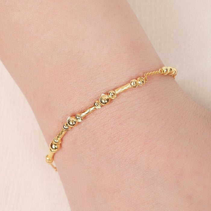 Delicate gold-plated 925 Sterling Silver beaded bracelet on a woman's wrist – Zavya