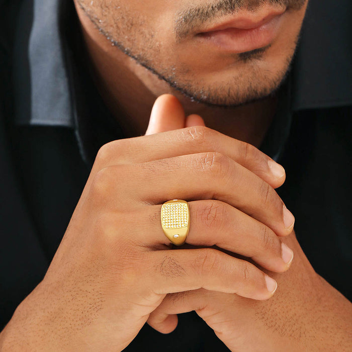 Man wearing a gold plated 925 Sterling Silver CZ ring on clasped hands. Ideal jewellery gift for him – Zavya