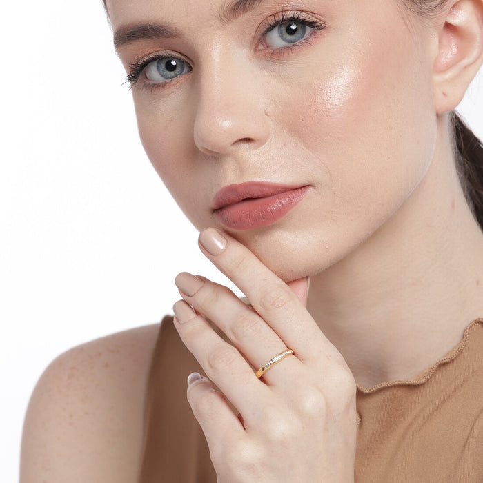 Woman touching her face wearing a gold plated 925 Sterling Silver CZ ring. Women's jewellery – Zavya