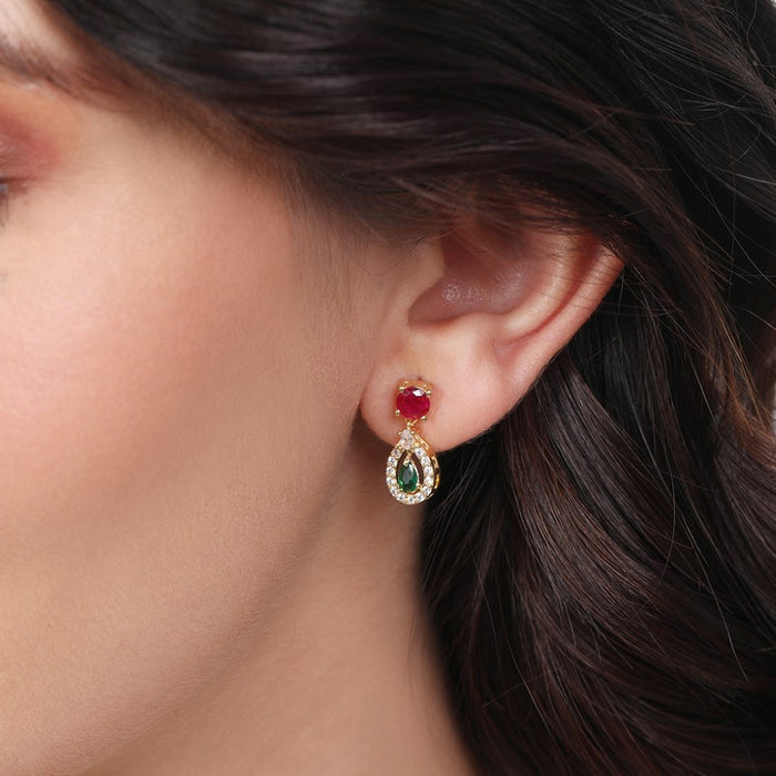 Woman wearing 925 Sterling Silver gold-plated tear drop earrings with red & green stones. Women's jewellery – Zavya