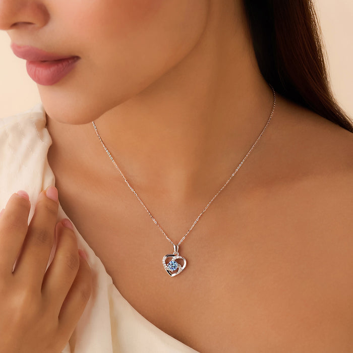 Woman wearing a 925 Sterling Silver heart pendant necklace with a blue stone for women – Zavya