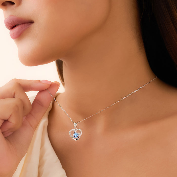 Woman wearing a 925 Sterling Silver necklace with a blue stone heart pendant. Women's jewellery – Zavya