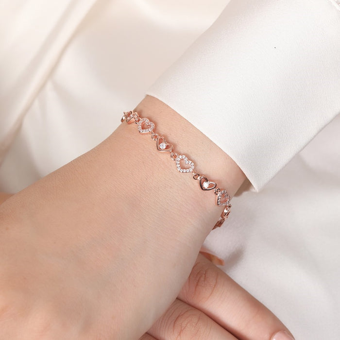 Rose gold 925 Sterling Silver heart bracelet on a woman's wrist. Fine jewellery for women – Zavya