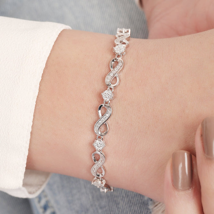 Woman wearing a CZ-studded infinity 925 Sterling Silver bracelet. Elegant jewelry for women – Zavya