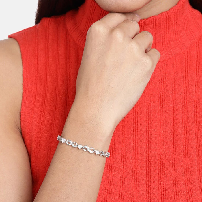 Woman wearing a CZ-studded 925 Sterling Silver bracelet on her wrist. Silver jewelry for women – Zavya