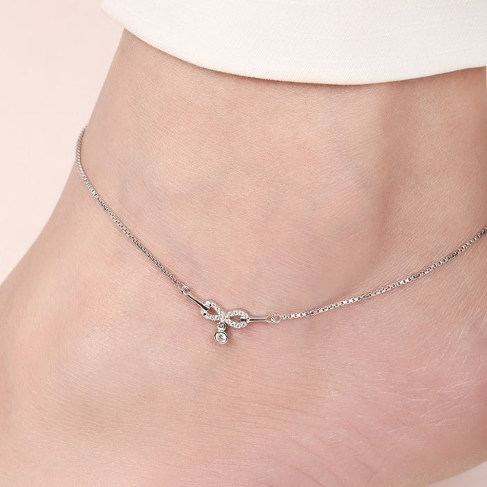Woman wearing a 925 Sterling Silver anklet with a sparkling infinity charm. Women's silver jewellery – Zavya